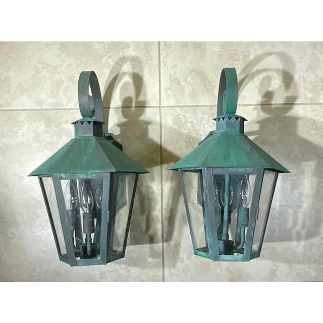 this exceptional pair of vintage outdoor/indoor wall lanterns. Crafted from heavy, solid copper and brass, these lanterns...
