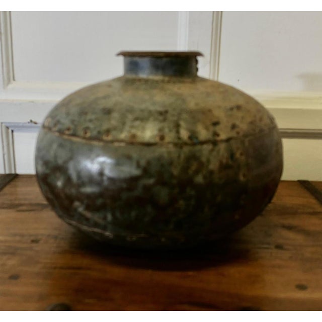 North African Round Metal Water Vase A rather primitive piece, it his made from riveted iron plates, it is circular with...