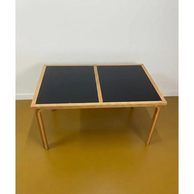 Vintage magnus olesen table, perfect for mid-century modern decor and offices. This 1950s danish table with a two-tone top...