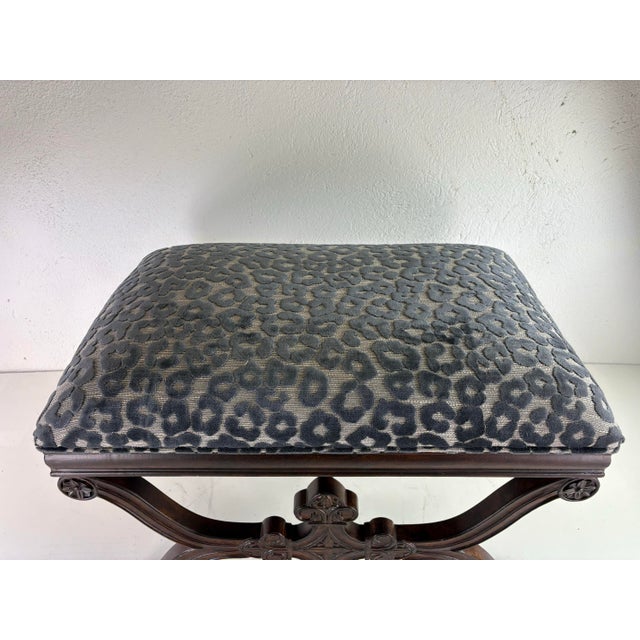 This is a vintage Spanish Renaissance style newly upholstered bench. This bench has a dark walnut finish to the surface...