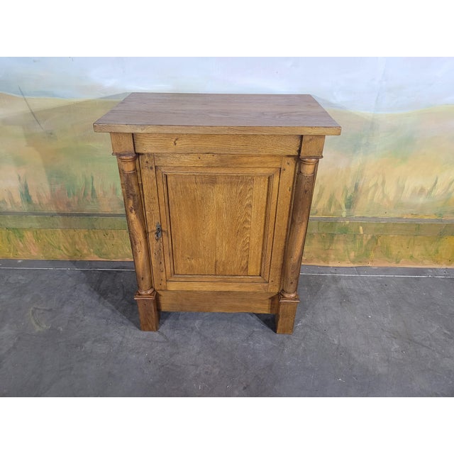 Charming antique jam cupboard in solid oak, dating from the Empire period. This small rustic piece is captivating thanks...