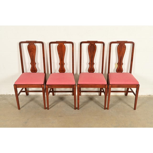 A gorgeous set of four Federal or Hepplewhite style dining chairs In the manner of Baker Furniture USA, Circa 1940s Carved...