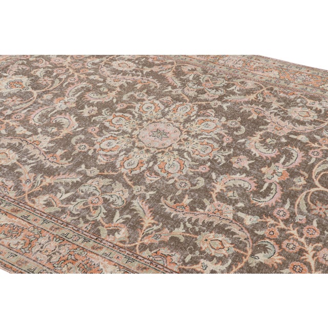 Hand-knotted in wool, this 6x9 vintage rug originating from Turkey, circa 1950-1960, is a very special piece, featuring a...