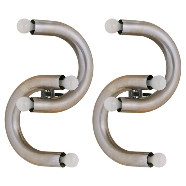 A rare 1970s Italian sconce by Stilux, formed from interlocking arcs of tubular chromed steel. Each sweeping curve holds a...