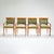 A set of four elegant armchairs crafted from cherrywood in early 19th-century France. The chairs rest on tapered legs and...