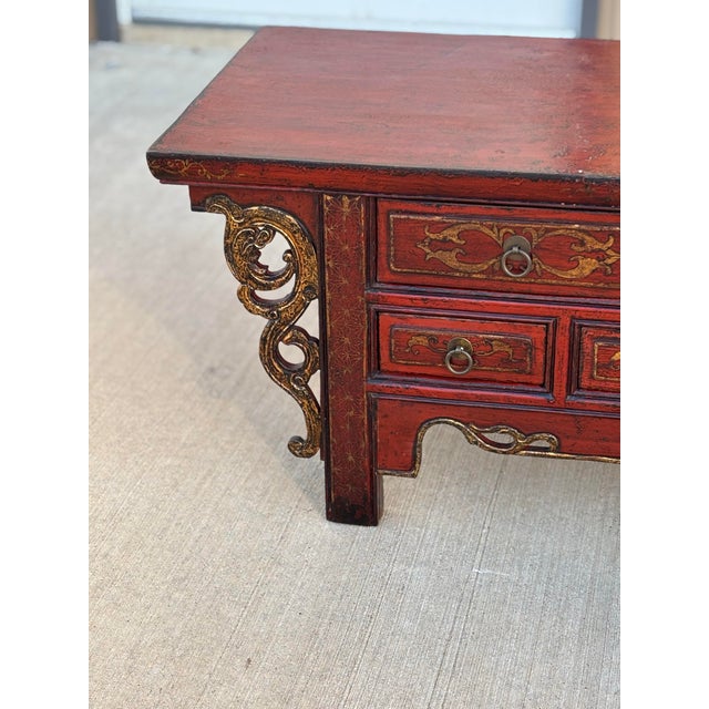 This traditional Chinese antique red lacquered wooden table is a striking expression of classical Chinese craftsmanship,...