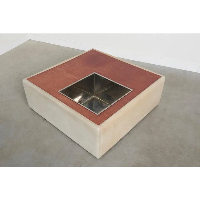 Remarks: Square coffee table with plant stand, 1970s design. Grey leather upholstered sides with zinc plant stand / bar....