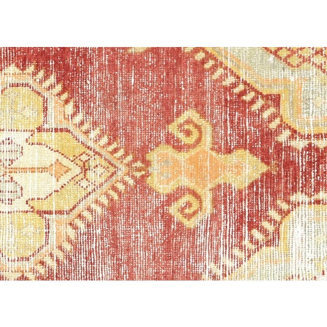 This Vintage Turkish Oushak Rug, measuring 2'7" x 5'6", is carefully handwoven with wool on a wool foundation in the...