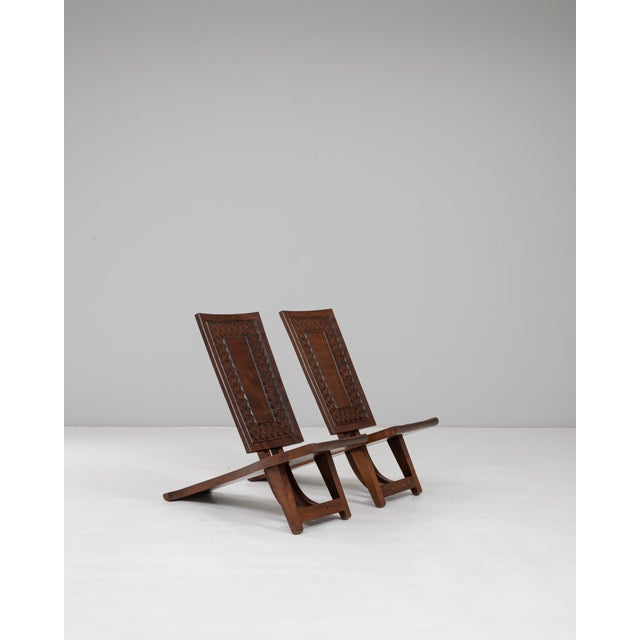 These 20th Century African wooden carved chairs from Congo showcase the sculptural elegance and rich craftsmanship...