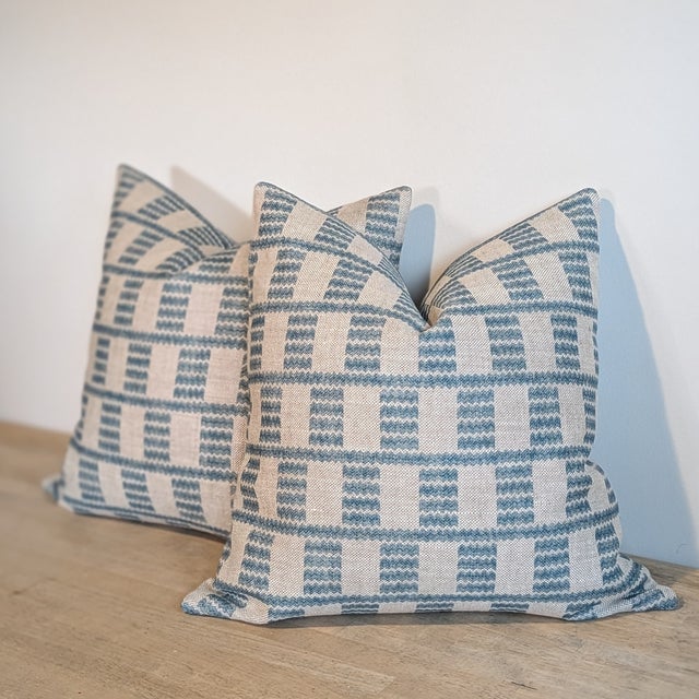 Fermoie Cover Pillows in Blue feature geometric waves in shades of medium blue on a neutral heavyweight linen. Invisible...