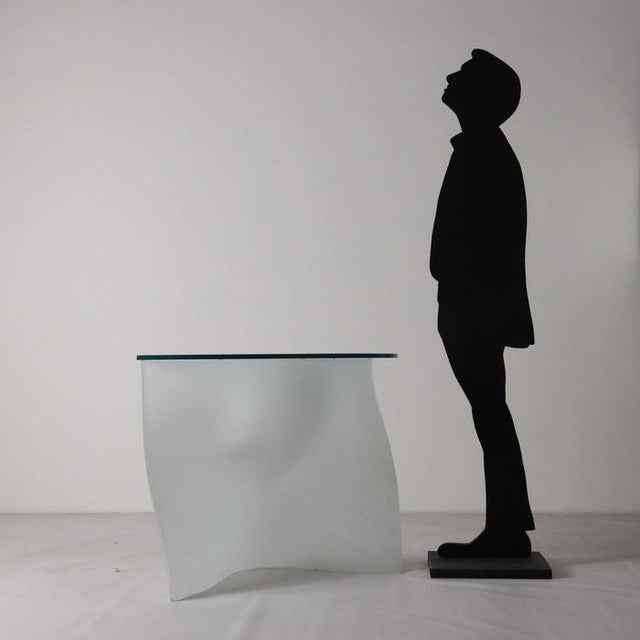 Console with curved white glass base with sandblasted finish and smoked glass top. This piece is attributed to the...