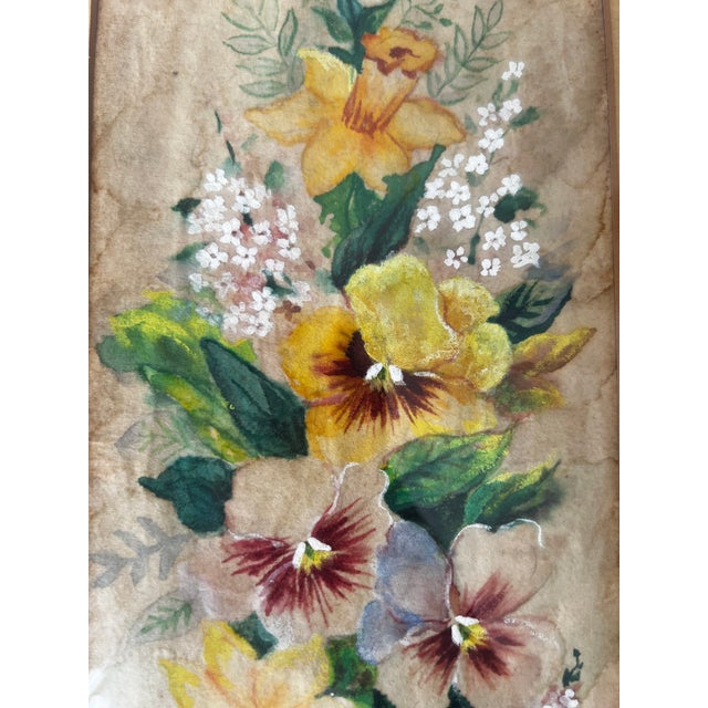 A graceful floral composition signed E. Barton, featuring golden daffodils, richly shaded pansies, delicate white flower...
