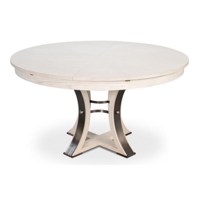 Whitewashed oak and curved, iron-detailed supports create a pale, sculptural surface that expands for dining. The pale oak...