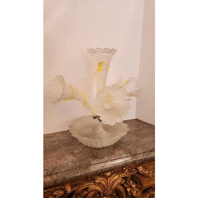 This listing features a glass epergne with four flutes that have yellow glass intertwining vines. The diameter of the bowl...