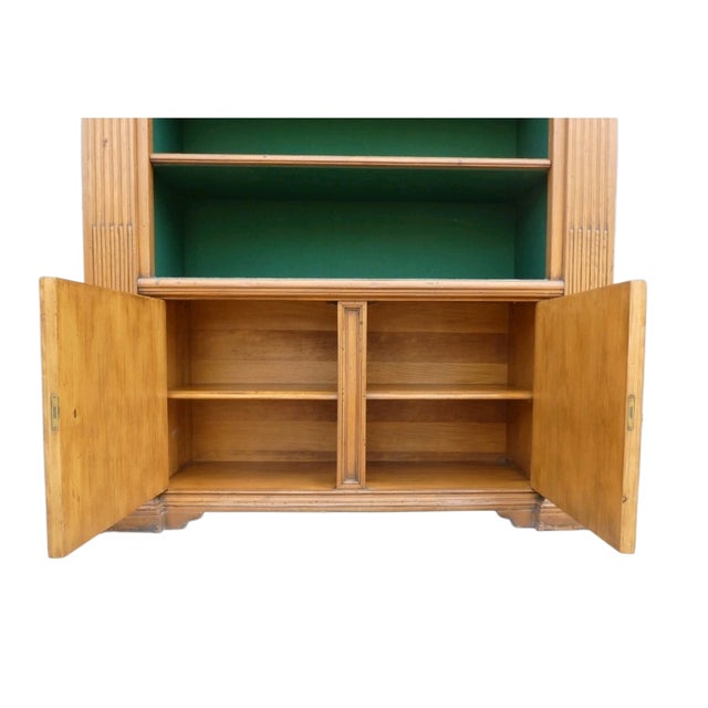 Solid wood bookcase with covered shelves. Featuring both front and side shelves, as well as a double-door closed compartment.