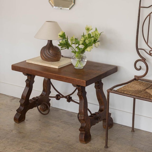 Beautiful 19th century wood and iron trestle table from Spain. Rectangular top, four carved wood legs, and beautiful...