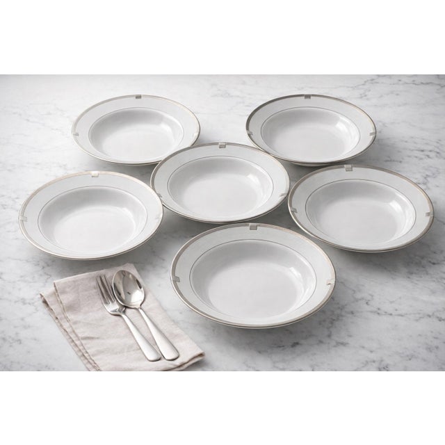 A refined set of six Mikasa Imperial Platinum soup bowls, crafted in fine china with a sleek platinum-banded rim and...