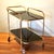 This bar cart was made in Germany in the 1950s. The elegant shape made of solid brass is typical 1950s design. The upper...