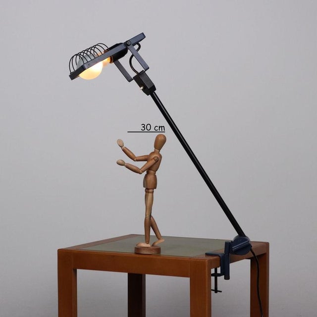 Table lamp with clamp, in enamelled metal and aluminium. This piece is attributed to the mentioned designer/maker. It has...