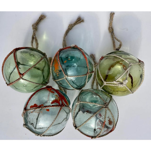 Set of five Christmas ornaments crafted from vintage blown glass Japanese fishing floats in assorted shades of aqua &...