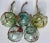 Set of five Christmas ornaments crafted from vintage blown glass Japanese fishing floats in assorted shades of aqua &...