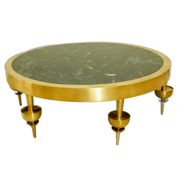 Modernist Art Deco style circular polished brass coffee table with 6 decorative legs and a green Italian marble top....