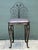 This elegant vintage vanity chair captures the essence of Mid-Century Hollywood Regency style with its ornate wrought iron...