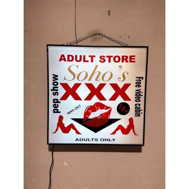 Original retro-style illuminated wall sign with iconic "Soho's XXX" graphics. Uniform internal illumination, visually...