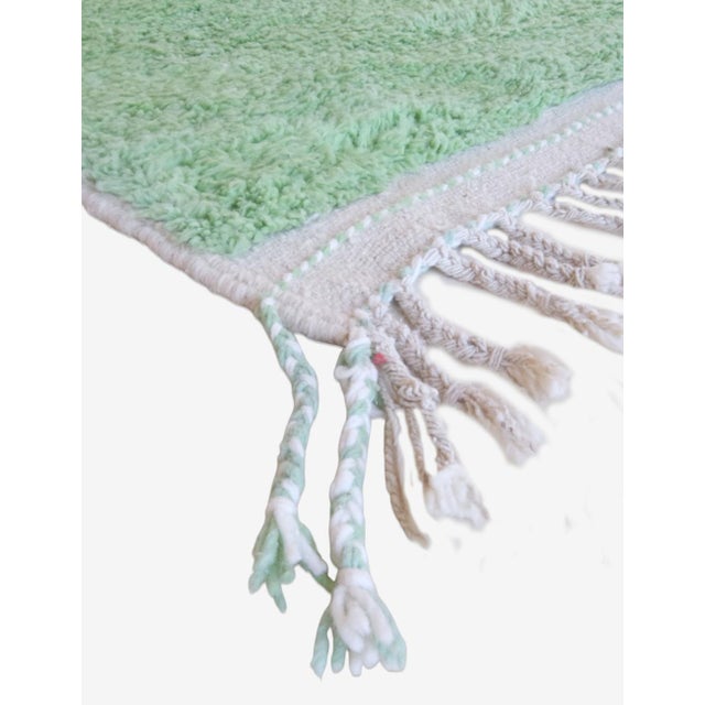 This handwoven contemporary Moroccan rug, measuring 10.2 by 8.6 feet, features a neutral palette that effortlessly...