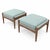 An elegant pair of ottomans featuring warm walnut bases and softly textured seafoam green chenille upholstery. Each frame...