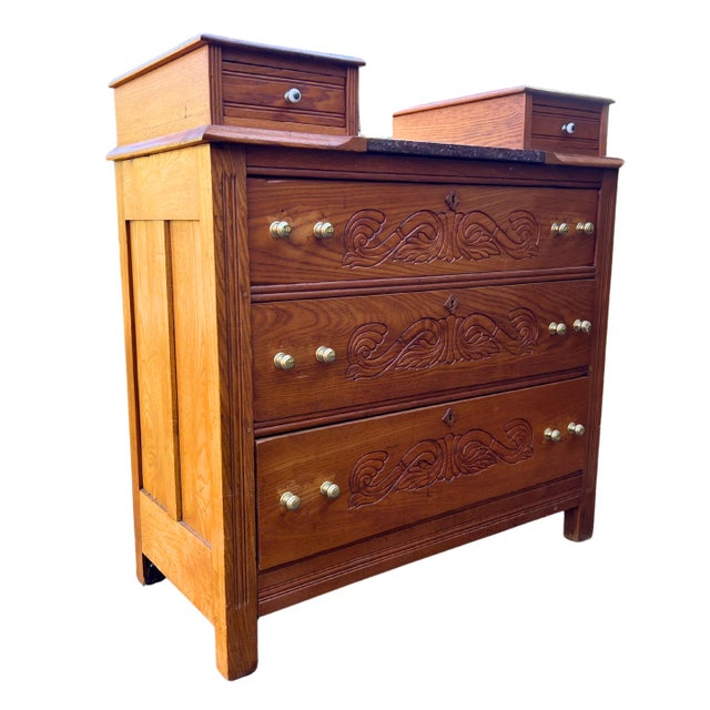 Beautiful, five-drawer, antique Victorian drop-center dresser, made from rich oak wood. Each of the main three drawers has...