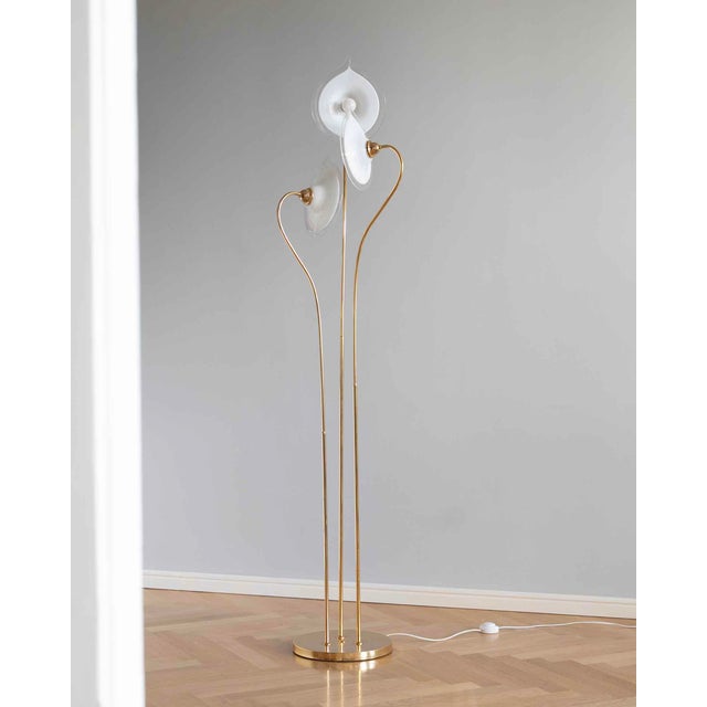Murano floor lamp from the 1970s with three white floral shades, brass base and decorative brass details. Professionally...