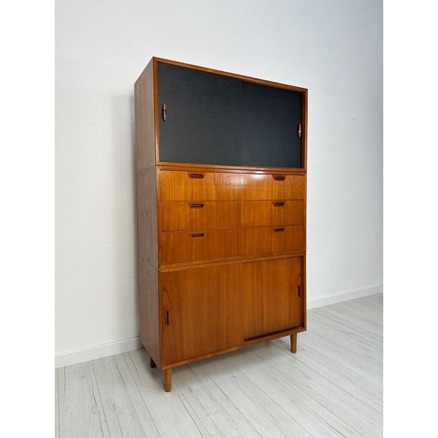 A beautifully crafted three-piece cabinet from the 1960s, made in denmark and executed in warm teak wood. This piece...