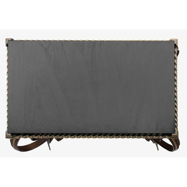 An elegant and sculptural French coffee table dating from the 1970s, combining a substantial Belgian black marble top with...
