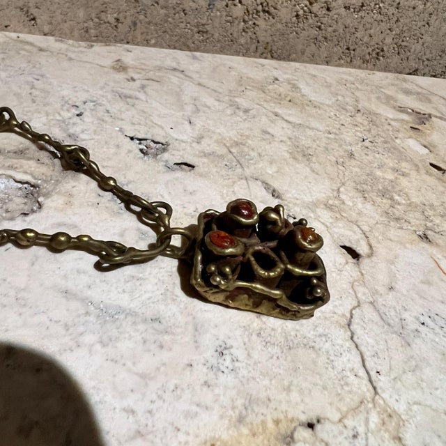 AMBIANIC presents 1970s Pal Kepenyes Brutalist Necklace Brass 10 h 9.75 chain .5 d x 1 w preowned vintage Refer to images