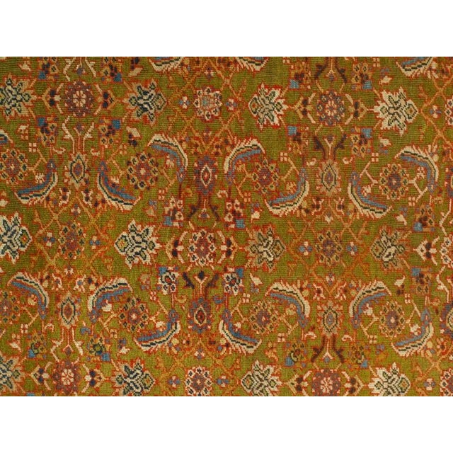 This antique rug features a highly unusual Olive green field—an element rarely seen carpets. Woven around 1900, it...