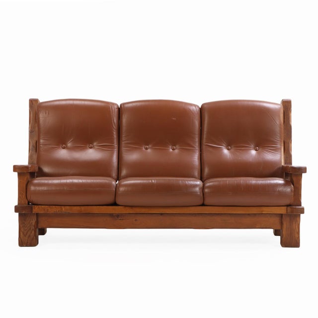 A striking example of mid-century European craftsmanship, this French heavy oak sofa frame, circa 1960, embodies the bold,...