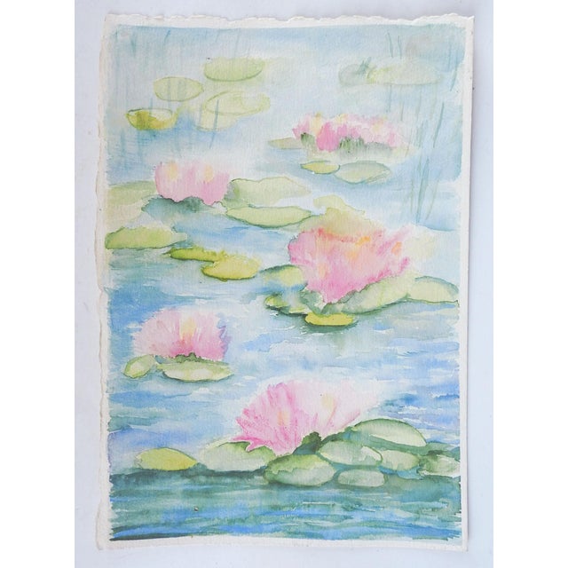 Late 20th century watercolor on paper painting of pink water lilies. Unsigned. Unframed.