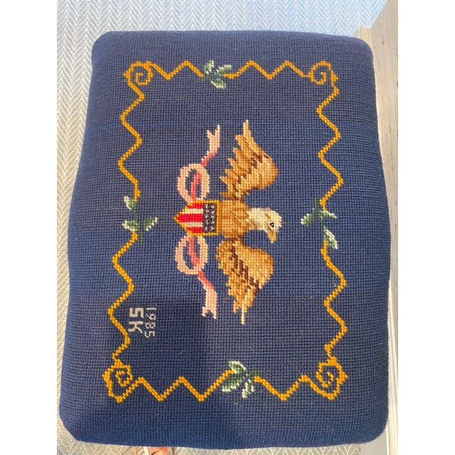Needlepoint covered bench with American Eagle on navy blue ground. French revival style base.. Measures 19.5 W x 14.5 D x...