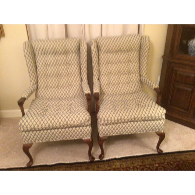 These Ethan Allen Wing Chairs were made in the 1990s. The exposed wood frame features simple turned arm post, cabriole...