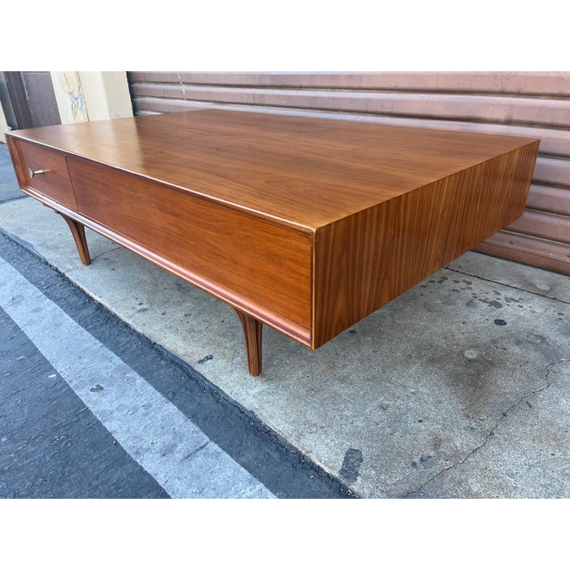Vintage walnut coffee table designed by Robert Baron for Glenn of California. Large, well built coffee table with a pass...