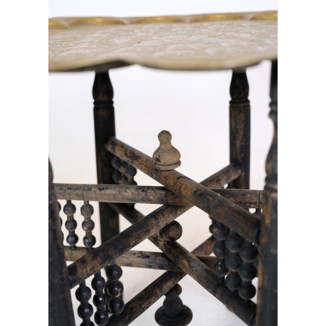 Indian tray table in the form of a brass tray and wooden base with carvings from around the 1950s. Dimensions in cm: H:51...