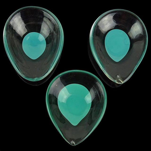 Beautiful vintage set of 3 Murano hand blown Tiffany blue / teal green Italian art glass small bowls or dishes. The pieces...