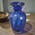 This vintage hand blown art glass vase features a stunning cobalt blue neoclassical design, showcasing the exquisite...