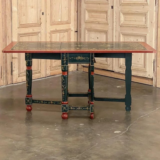 19th Century Swiss Hand-Painted Drop Leaf Table is a celebration of the natural spring time beauty of the Alpine country!...