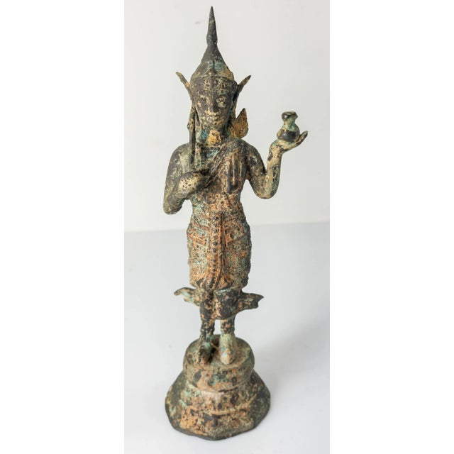We are selling this verdigris bronze South East Asian Thai or Burmese standing Buddha figure. We believe the Buddha figure...
