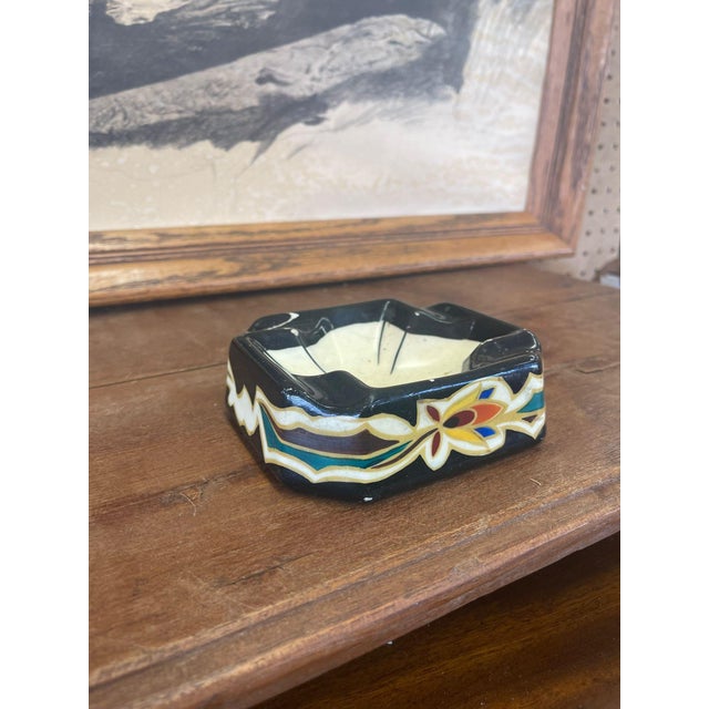 Traditional design atop this unique Ashtray. Maker mark on the bottom, stating that was made in Holland. Vintage Condition...