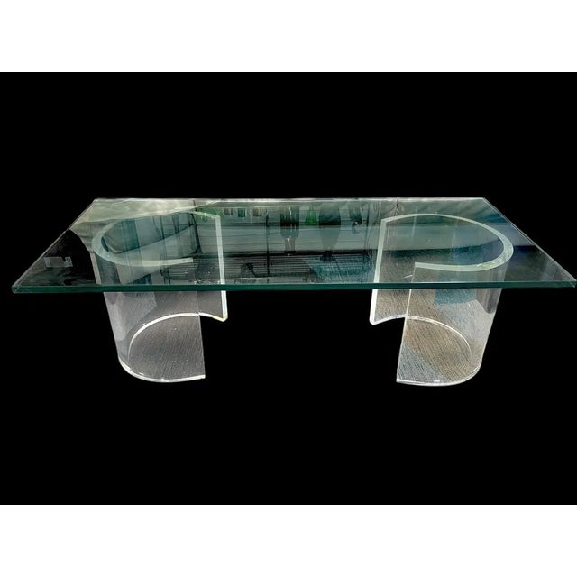 CONTEMPORARY GLASS TOP COFFEE TABLE WITH SCULPTURAL LUCITE BASE 16" X 54" X 24" APPROX -Contemporary glass-top coffee...