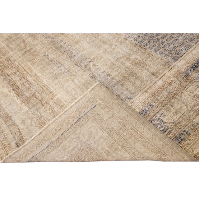 Beautiful Sivas hand-knotted wool rug with a beige field. This piece has blue borders and an accents layout on a palmettes...