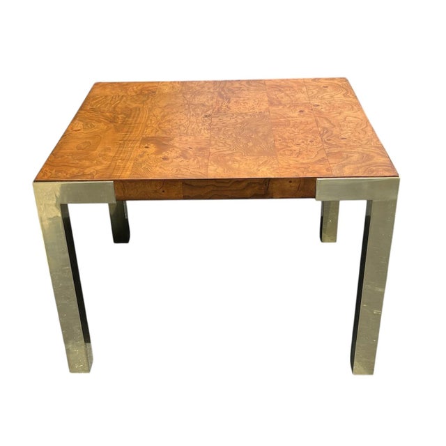Olive burl side table with brass legs in the style of Milo Baughman. Striking Mid-Century Modern table is veneered with...